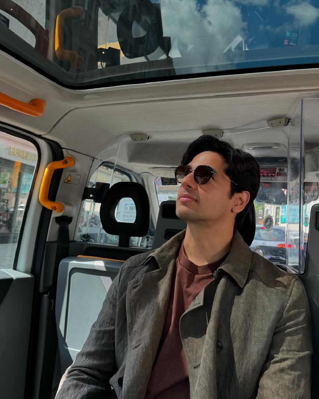 Sidharth looked dapper in a sleek slate trench coat during one of his trips with Kiara.  