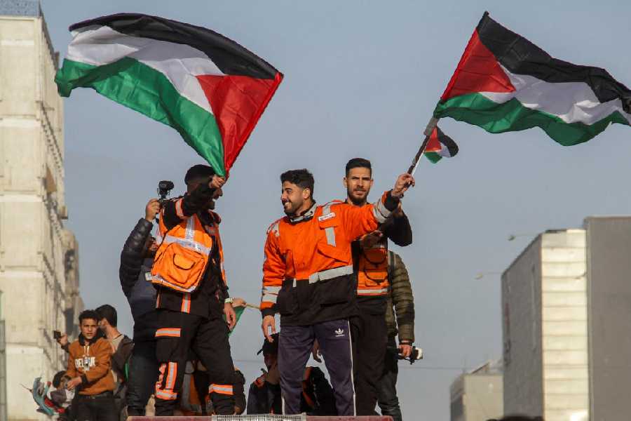 Members of the Palestinian civil emergency service celebrate despite a delay in the ceasefire between Israel and Hamas over the hostage list, in Gaza City, January 19, 2025