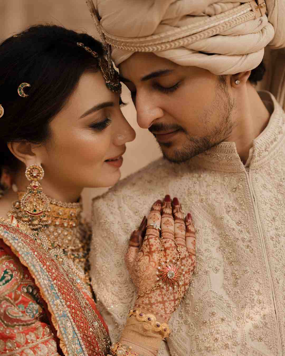 Dharal embraced Darshan for a picture. Gold-toned jewellery, smokey eyes, tinted cheeks and peach-hued lips perfectly complemented Dharal’s bridal ensemble. 