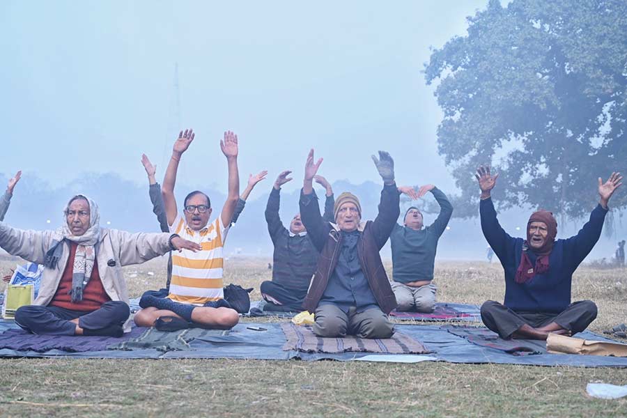 Seniors practise yoga on a foggy Maidan on Friday morning