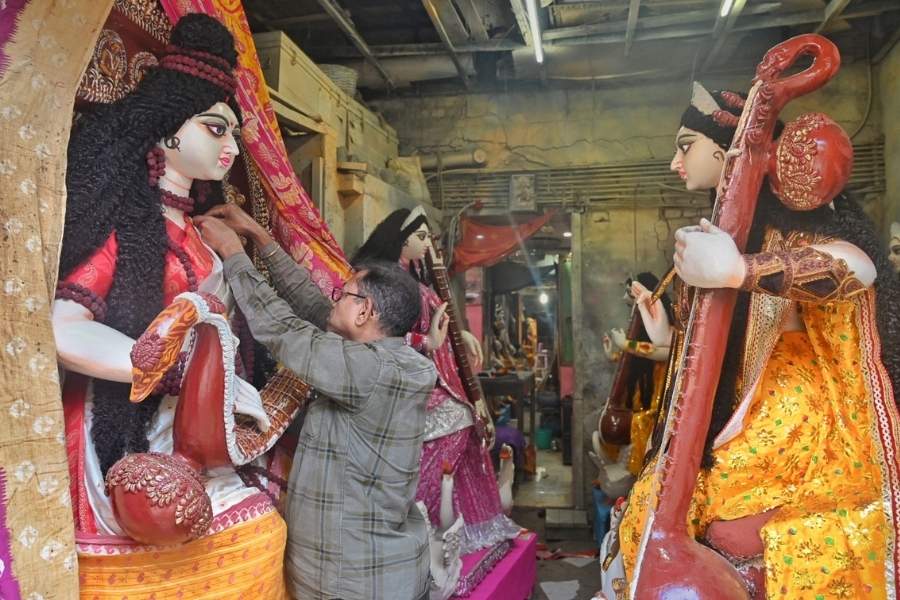 An artist puts the final touches to a Saraswati idol at Kumartuli on Monday  