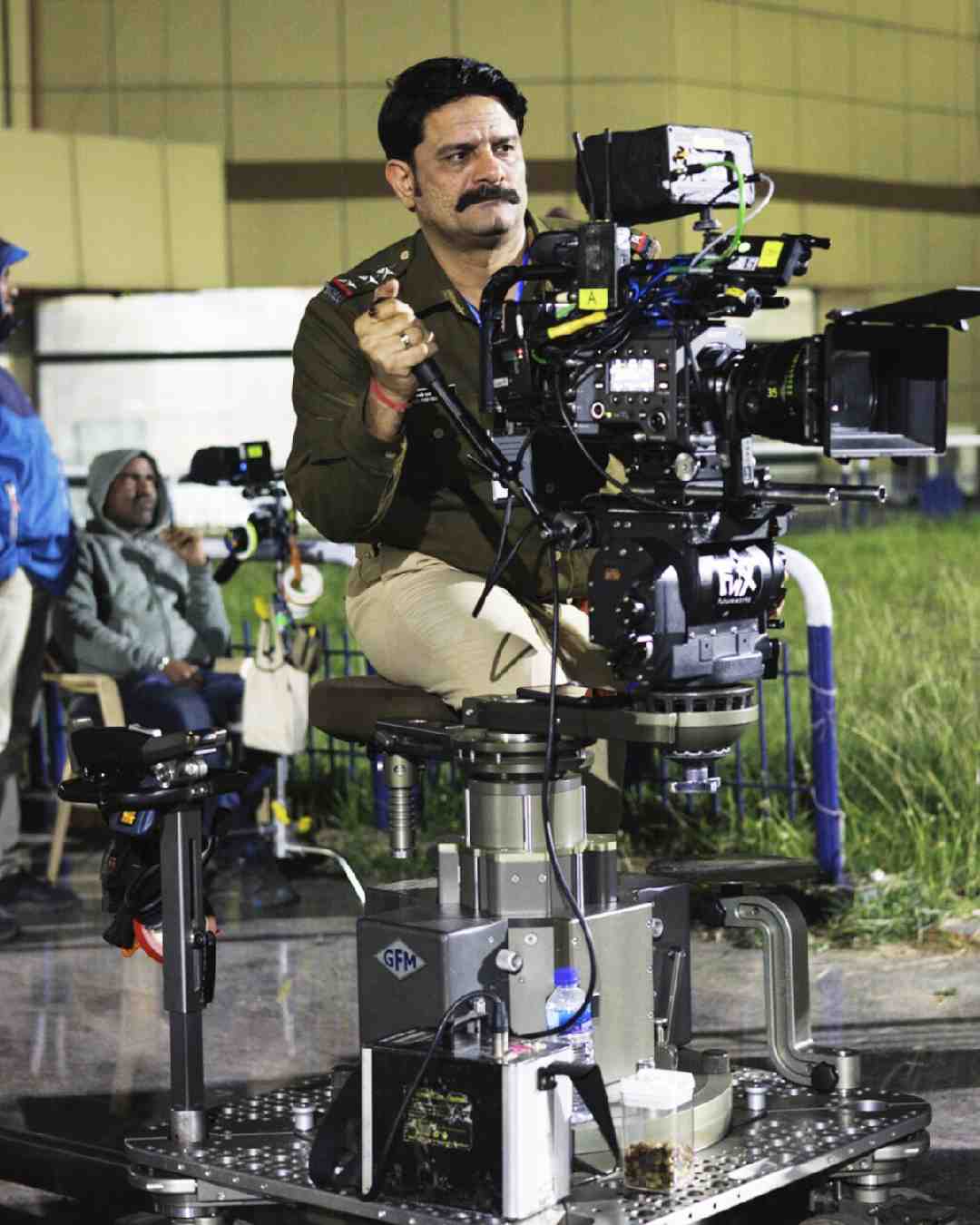 Jaideep Ahlawat reviewed shots on the set of the crime thriller series in one of the photos.