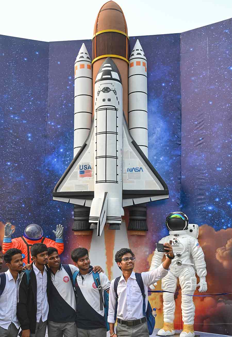 Students took selfies in front of a giant replica of a NASA rocket