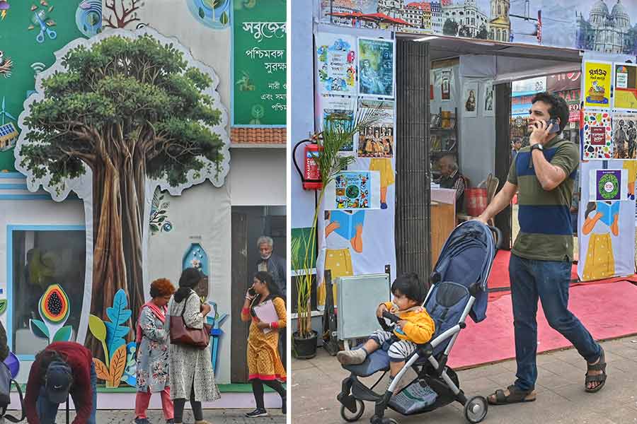 Before starting on his primer, a toddler took a stroll around the book fair ground on a perambulator on January 30 and (right) a cutout of a tree stood as a reminder of the necessity of conservation of nature