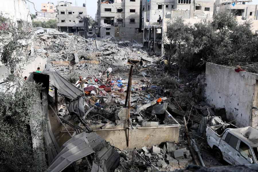 A Palestinian man inspects the site of an Israeli strike on a house that took place on Monday, in Zawayda in the central Gaza Strip, July 1, 2025.