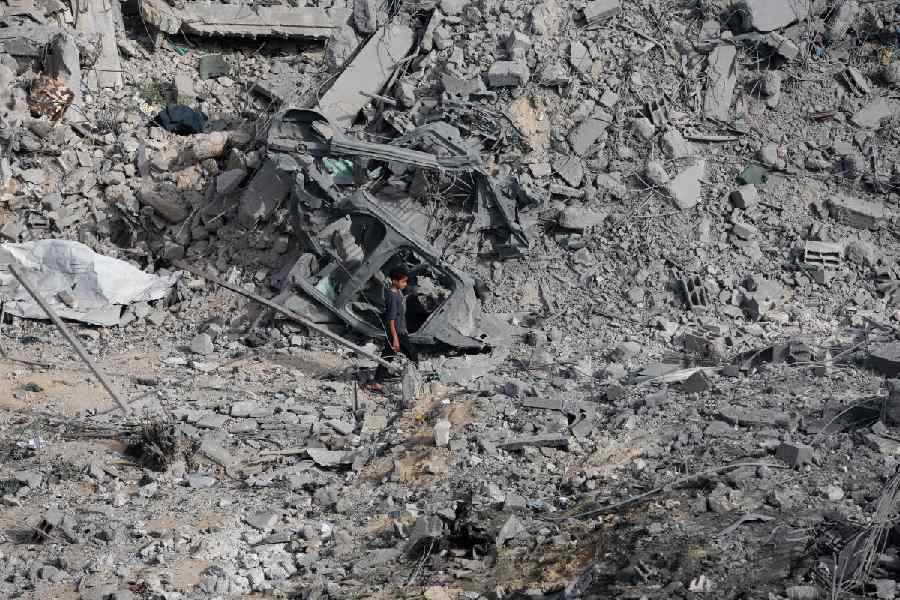 A Palestinian walks at the site of an Israeli strike on a house that took place on Monday, in Zawayda in the central Gaza Strip, July 1, 2025.