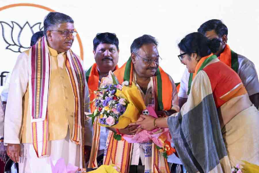 BJP leader Locket Chatterjee felicitates Samik Bhattacharya when the latter took charge as the Bengal party chief, as MP Ravi Shankar Prasad looks on in Calcutta on Thursday. (PTI picture) 