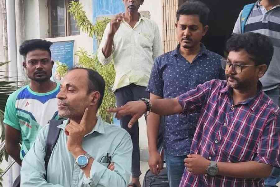 Subhasis Panda, the principal of Government General Degree College in Chapra, Nadia, points to a mark of assault near his left ear.  Picture by Abhi Ghosh