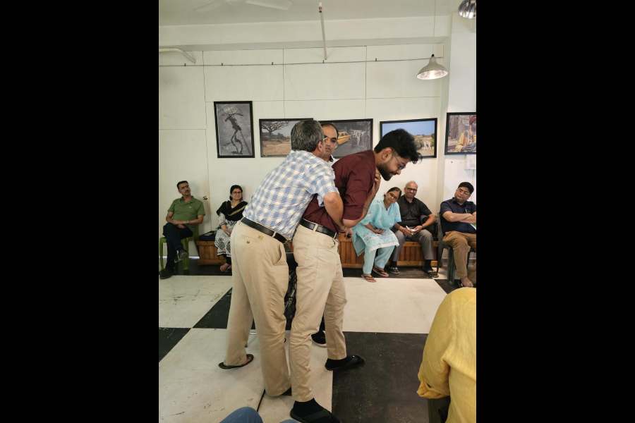 Dr Udipta Ray demonstrates the Heimlich manoeuvre on a volunteer in an imagined scenario of choking