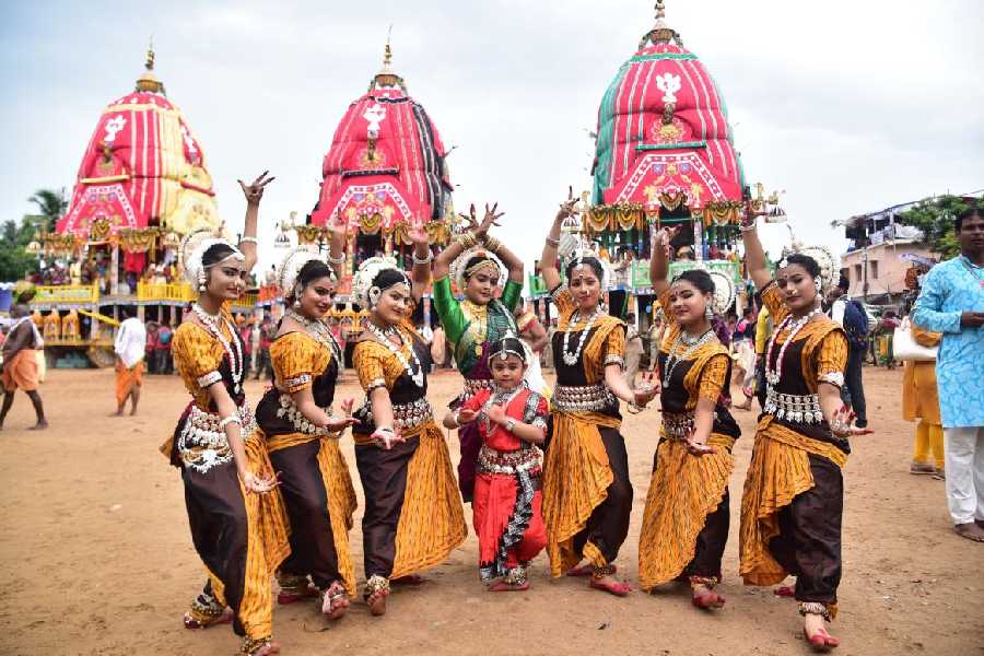 A group of dancers in front of the chariots in Puri on Saturday. 