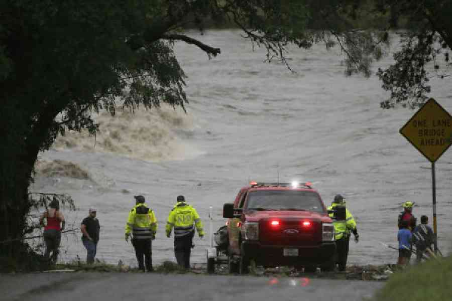 First responders scan the banks of the Guadalupe river for people swept away by flooding in Ingram, Texas, on Friday. (Michel Fortier/The San Antonio Express-News via AP)