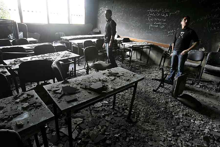 Palestinian students and visitors inspect the damaged and burnt laboratories and classrooms of The Islamic University, a scientific stronghold of Hamas, February 6, 2007 in Gaza City, Gaza Strip.