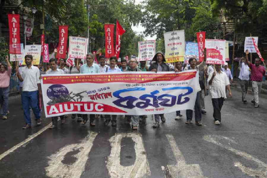Members of All India United Trade Union Centre (AIUTUC) take part in a rally as part of a 24-hour nationwide general strike called by trade unions to protest against the central government's alleged anti-labour policies, in Kolkata