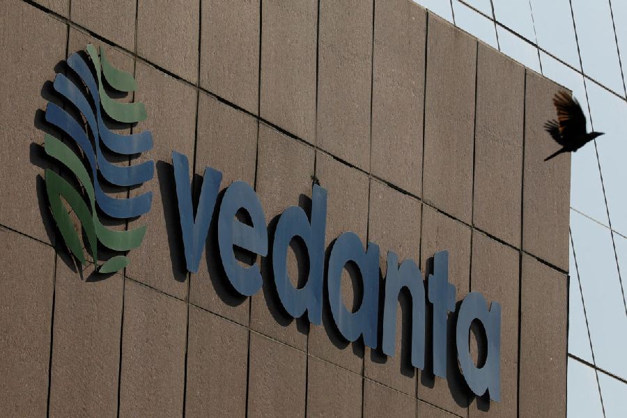 A bird flies past the logo of Vedanta installed on the facade of its headquarters in Mumbai, India.