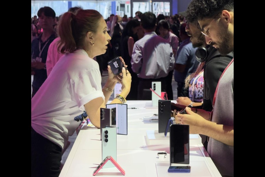 Tech enthusiasts discuss the new Samsung products at an event in New York.