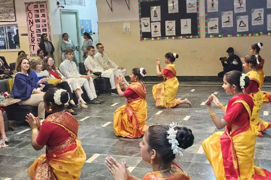 Students of St. Joan's School perform a dance routine with the Russian students in the audience.