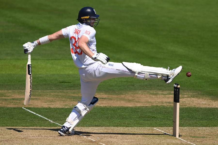 Jamie Smith of England attempts to stop the ball hitting his stumps with his foot during day two of the Third Test Match between England and India at Lord's