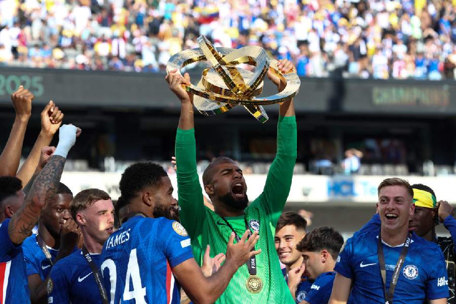Chelsea FC goalkeeper Robert Sanchez lifts the trophy as he celebrates with teammates after Chelsea won against Paris St Germain in the FIFA Club World Cup final