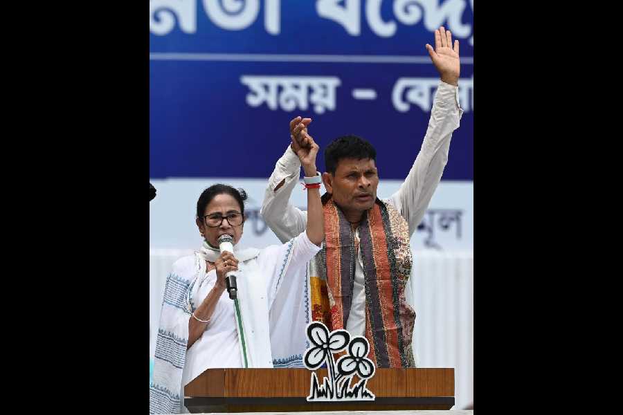 Mamata Banerjee with Uttam Kumar Brajabasi on the dais of the Martyr's Day event in Esplanade, Calcutta, on Monday.