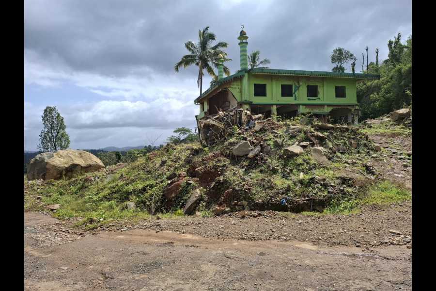 A dilapidated mosque and a mangled remains of an automobile at Chooralmala. A huge boulder is also seen which came crashing from the other side of the road