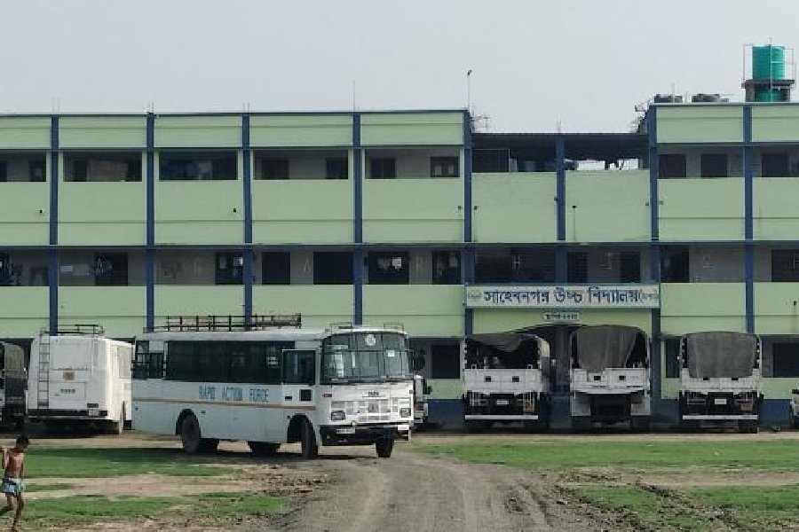 Vehicles of security personnel parked on the campus of Sahebnagar High School at Dhulian on Monday