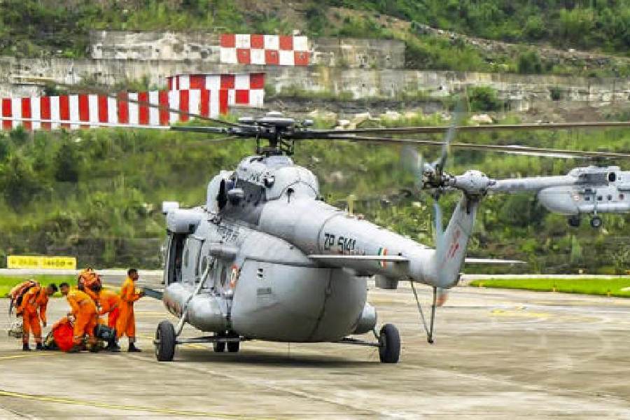 NDRF personnel equipped with satellite phones and emergency supplies prepare to board a V-5 helicopter for deployment in landslide-hit areas, at Pakyong Greenfield Airport, Sikkim