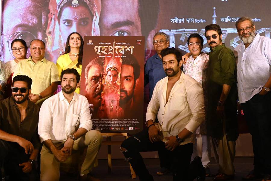 The cast and crew posed with the poster of 'Grihapravesh'