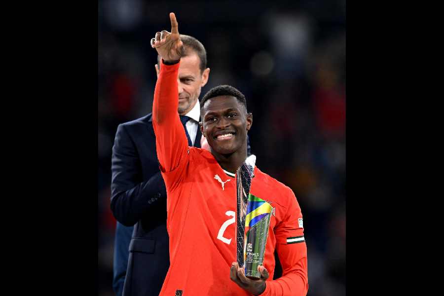 Portugal's Nuno Mendes celebrates with a trophy after winning player of the tournament