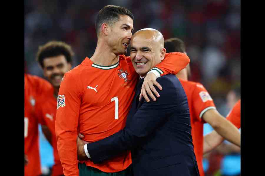 Portugal's Cristiano Ronaldo and coach Roberto Martinez celebrate after winning the Nations League