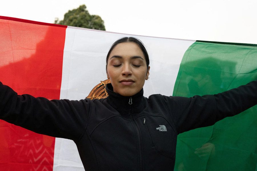 A demonstrator marches with a Mexican flag in the Mission District during a protest against federal immigration sweeps, in San Francisco, California, U.S. from local officials and logistical concerns from the police chief.