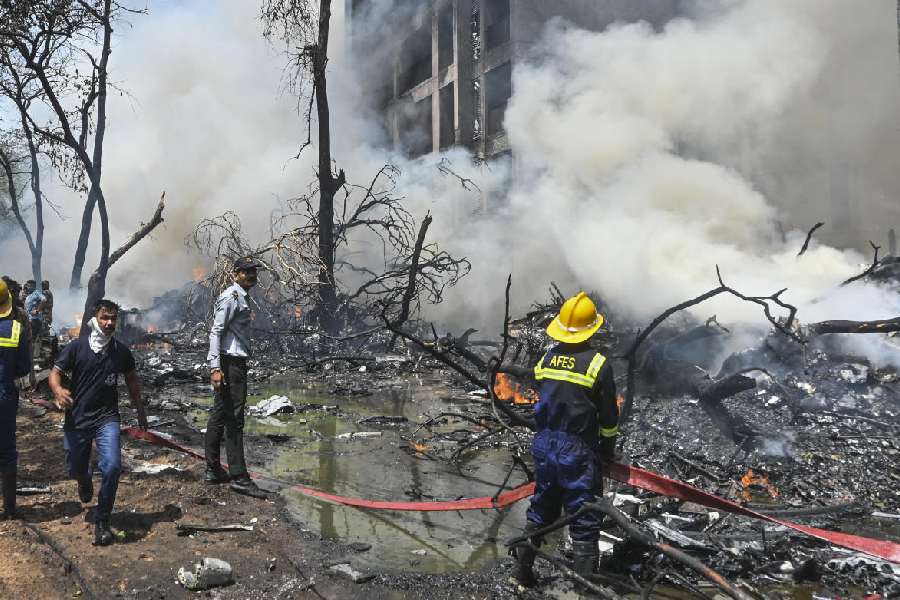 Fire and Emergency personnel at work following the Air India plane crash in Ahmedabad, Thursday, June 12, 2025. The London-bound Air India plane carrying 242 passengers crashed moments after taking off from the Ahmedabad airport.