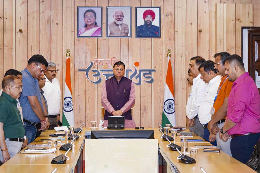 Uttarakhand Chief Minister Pushkar Singh Dhami pays tribute to the victims of the Air India plane crash, during a meeting with senior officials at the Chief Minister's residence in Dehradun on Friday