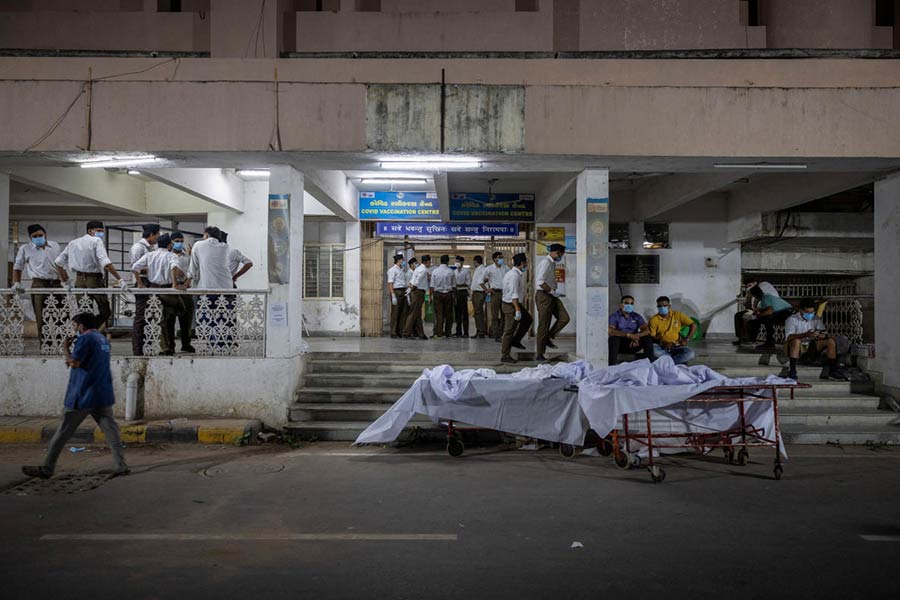 Volunteers stand next to stretchers for the victims