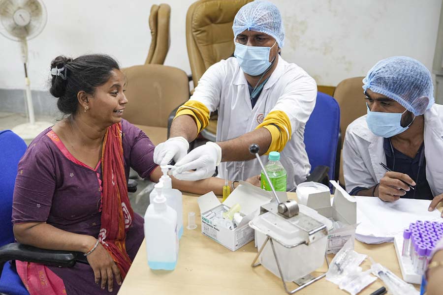 A relative of yesterday's Air India plane crash victim gives her DNA sample for identification of bodies at a hospital