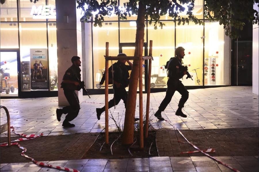 Israeli security forces run to take cover while missiles were launched from Iran