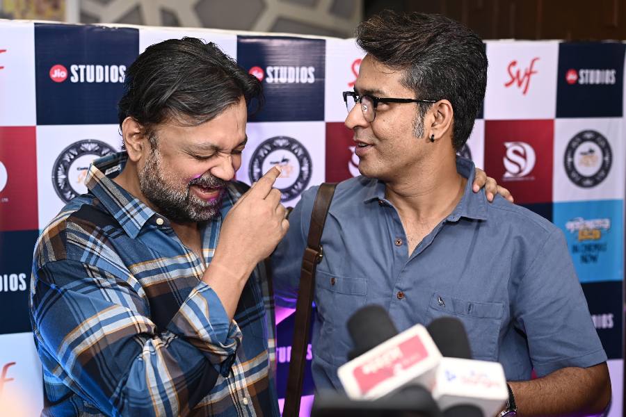 Filmmaker Srijit Mukherji shares a light-hearted moment with actor Anirban Bhattacharya at the screening.