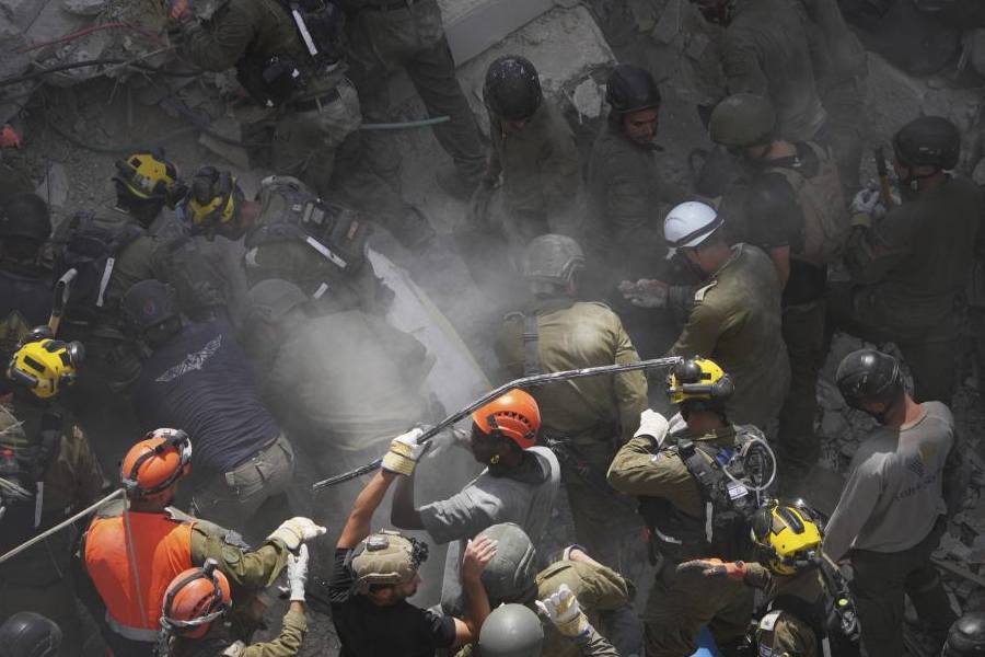 Israeli soldiers search for survivors amid the rubble of residential buildings destroyed by an Iranian missile strike in Bat Yam, central Israel, on Sunday, June 15, 2025.