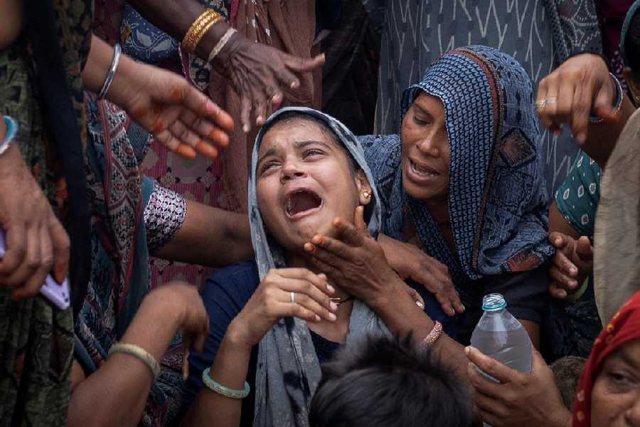 Dabu Patni, mourns as she waits for the body of her younger brother Akash Patni, 14, who died after an Air India Boeing 787-8 Dreamliner plane crashed during take-off from an airport, to arrive at his house for the last rites in Ahmedabad, India, June 15, 2025.