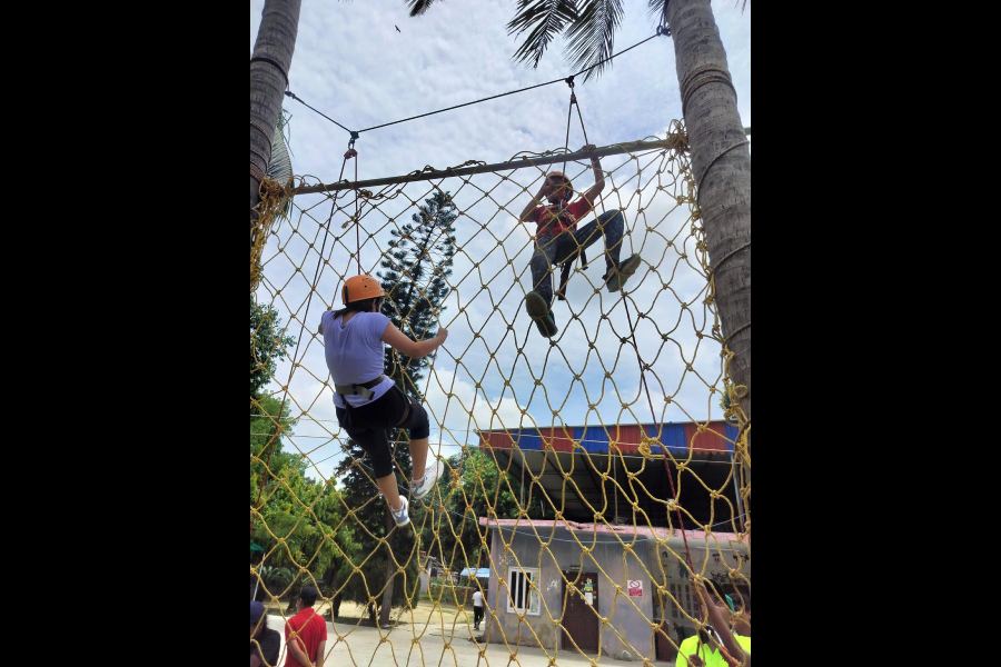 Participants of the summer camp take part in zipline and commando climbing