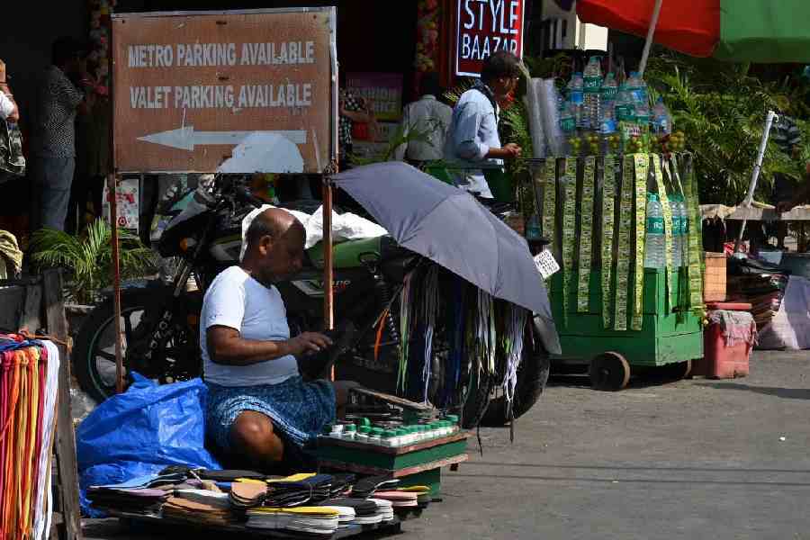 A cobbler on the street braves the scorching summer heat, just to make a living.