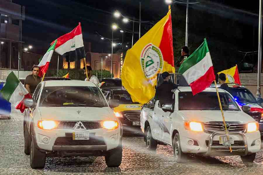 Supporters of the Shi'ite armed group Kataib Sayyid al-Shuhada celebrate in Basra after Iran launched a strike on Qatar's Al Udeid Air Base.