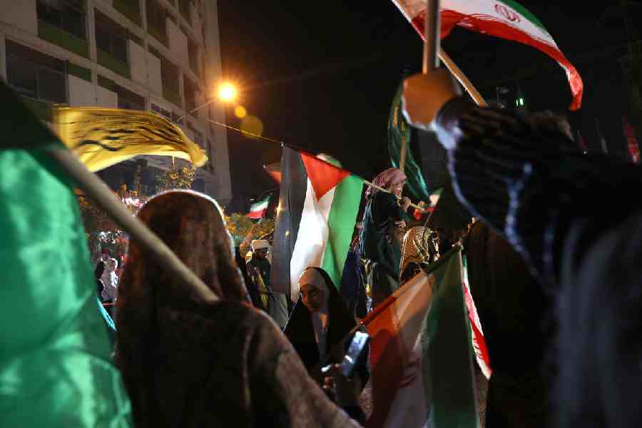Iranians celebrate following Iran's attack on U.S. military base in Qatar, amid the Iran-Israel conflict, in Tehran.