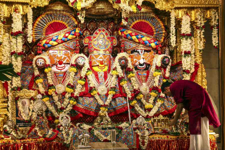 A priest prepares for the 'Netrotsav' ceremony ahead of the annual Rath Yatra procession of Lord Jagannath, Lord Balbhadra, and Goddess Subhadra, in Ahmedabad