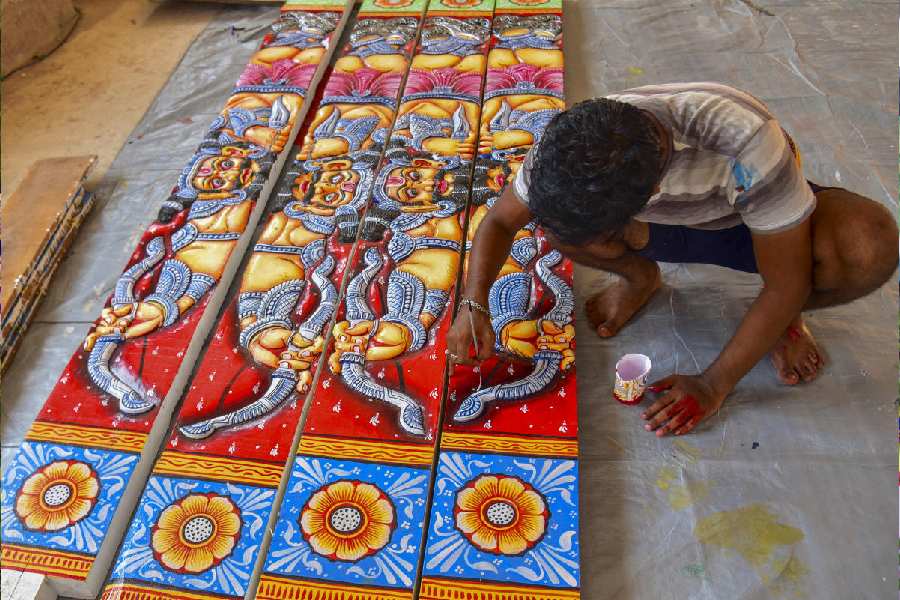 An artist paints the Rushi Patta (sacred motifs) for chariots