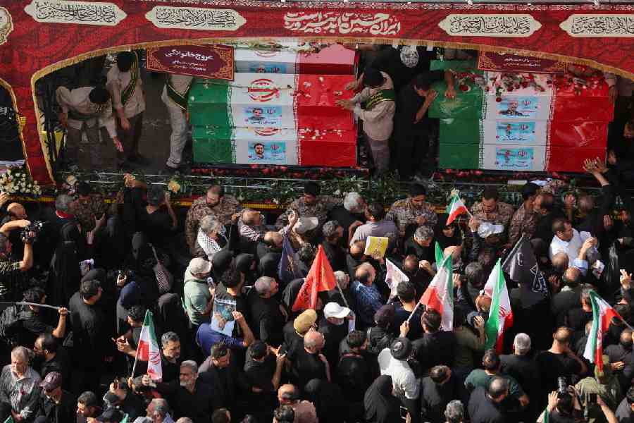People attend the funeral procession of Iranian military commanders and nuclear scientists killed in Israeli strikes, in Tehran, Iran.