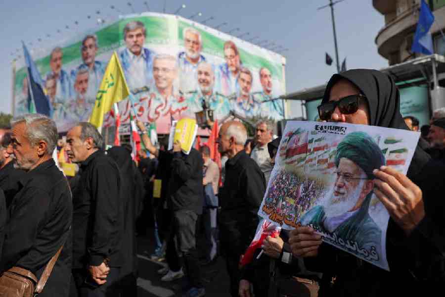 People attend the funeral procession of Iranian military commanders and nuclear scientists killed in Israeli strikes, in Tehran.