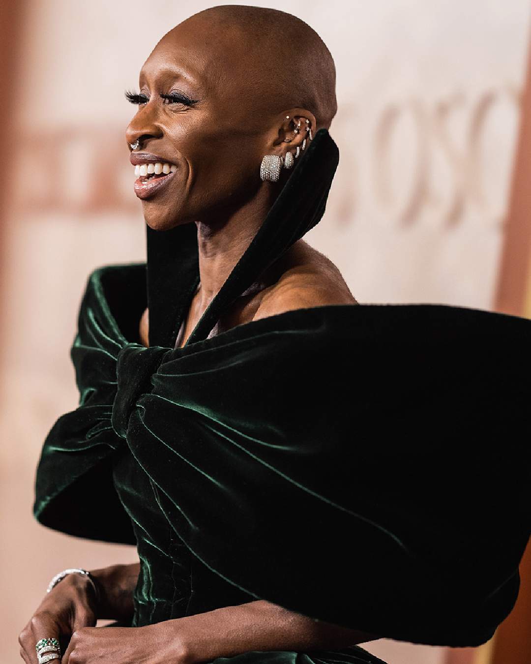 Grande’s Wicked co-star Cynthia Erivo opted for a deep green velvety Louis Vuitton gown featuring a dramatic bow in the front and face-framing collars.  