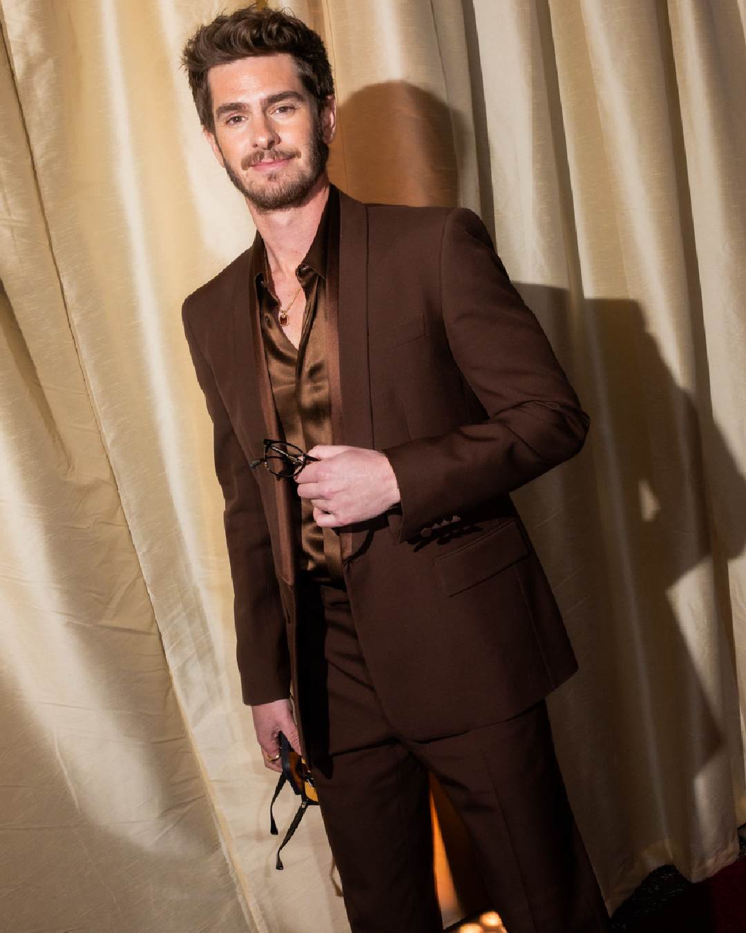 The Amazing Spider-Man actor Andrew Garfield looked dapper in a brown suit. 