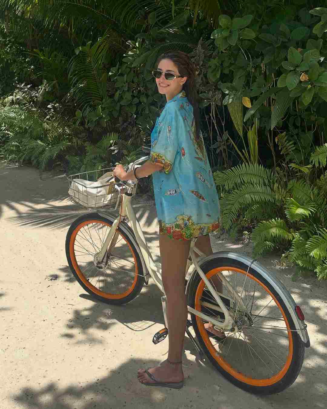 The CTRL actress kept it casual in a breezy shirt. She basked in the sun and cycled around during her vacation.  