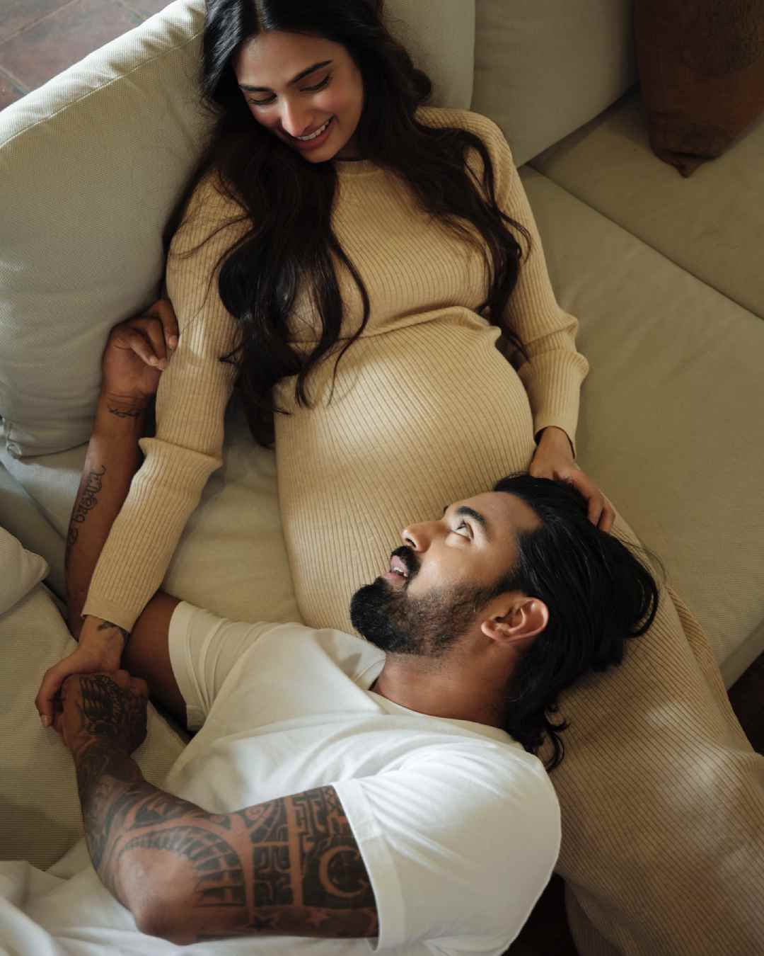 Father-to-be KL Rahul rested his head on Athiya’s lap and gazed into her eyes. Athiya looked gorgeous in a beige ribbed dress that accentuated her baby bump.  